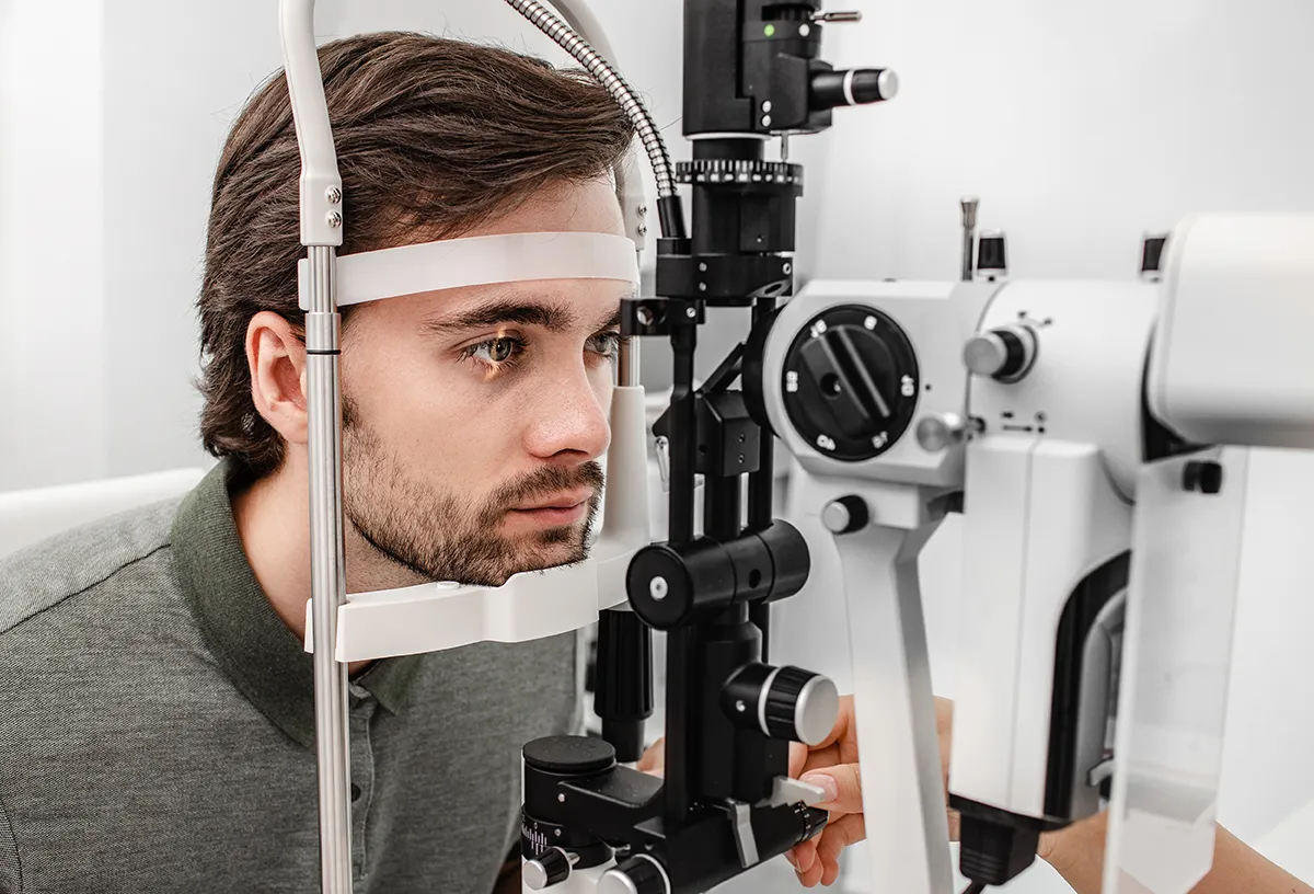 a young man getting an annual eye exam at the eye doctor's